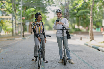Commuting to work with bicycle. Young business person cycling and riding electric scooter to office...