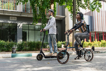 Commuting to work with bicycle. Young business person cycling and riding electric scooter to office in downtown district. Modern diversity people use eco transportation in city. Sustainable lifestyle.