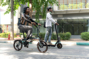 Commuting to work with bicycle. Young business person cycling and riding electric scooter to office in downtown district. Modern diversity people use eco transportation in city. Sustainable lifestyle.