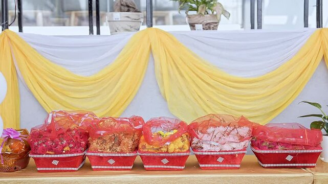 Closeup shot of various flowers arranged in baskets for worship at the religious event