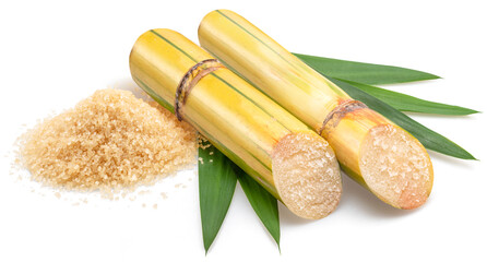 Sugarcanes stalks, sugar cane leaves and heap of sugar isolated on white background.