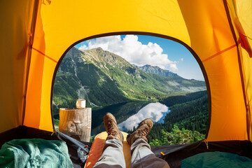 Spectacular view of nature from open tent entrance. The beauty of romantic trekking and camping.