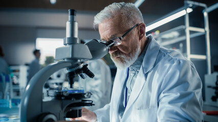 Medical Research and Development Laboratory: Middle Aged Head Scientist Working on Research...