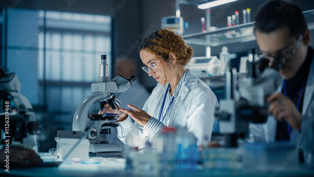 Poster hisplanic female bioengineer looking at dna samples under a microscope in a modern applied science l