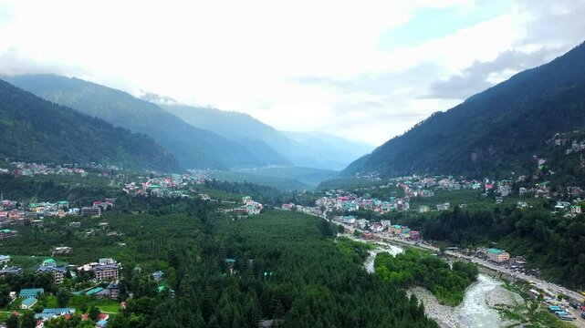 Aerial view of manali with the beas river in himachal pradesh India. Himalayan mountains and colourful local houses nestled in the hills of manali himachal pradesh India.