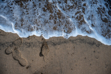 Soft wave of blue ocean on sandy beach.