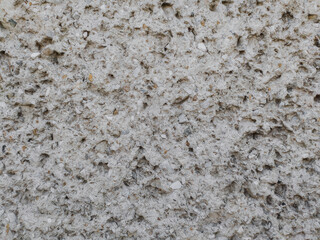 Concrete gray cement wall background with grain, closeup photo. Rough cement texture, showcasing...