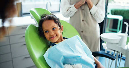 Dentist, consulting and child on chair happy for cleaning, tooth extraction and wellness....