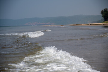 Soft wave of blue ocean on sandy beach.