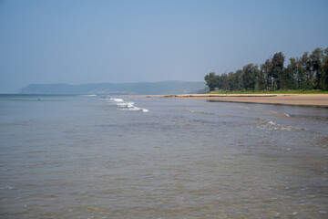 Soft wave of blue ocean on sandy beach.