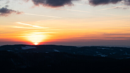 Colorful sunset over the Czech countryside. View from the Teplice-Adršpašské rocks of the Giant Mountains and the surrounding hills.