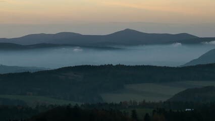 Colorful sunset over the Czech countryside. View from the Teplice-Adršpašské rocks of the Giant Mountains and the surrounding hills.