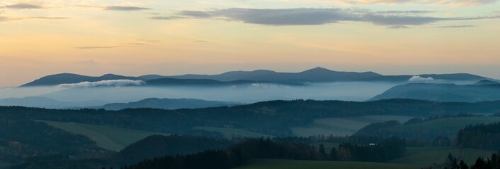Colorful sunset over the Czech countryside. View from the Teplice-Adršpašské rocks of the Giant Mountains and the surrounding hills.