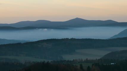Colorful sunset over the Czech countryside. View from the Teplice-Adršpašské rocks of the Giant Mountains and the surrounding hills.