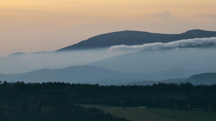 Colorful sunset over the Czech countryside. View from the Teplice-Adršpašské rocks of the Giant Mountains and the surrounding hills.