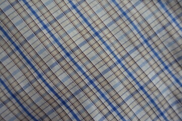 Texture of white, blue and brown checkered cotton fabric