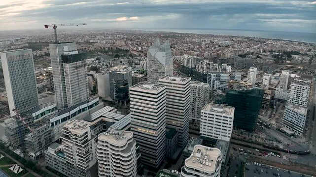 Twilight drone view of CFC with completed skyscrapers and active construction. This 4K footage highlights Morocco&rsquo;s urban growth and Africa&rsquo;s economic progress.