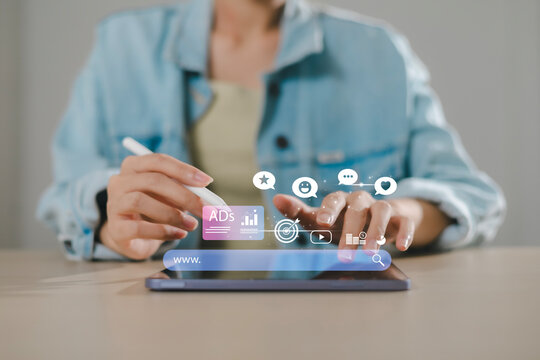 Businessman using hand touching on digital tablet to use marketing tools and check research visits to pay per click program on web page for online business and lifestyle concept. - Powered by Adobe