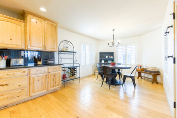 Cozy kitchen and dining area with natural wood accents and modern decor in a bright, spacious setting