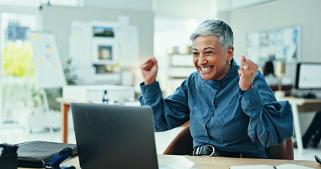 Mature woman, celebration and winning with laptop for good news, promotion or email at office. Excited, female person or employee with smile on computer for amazing offer, deal or prize at workplace