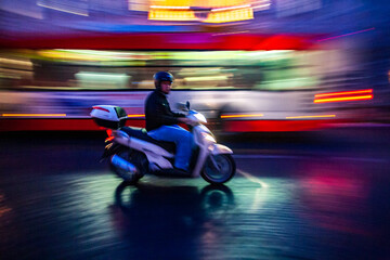 Rome, Italy, July 22 2017, A Roman Scooter Cruising Through the Streets of Rome During Twilight
