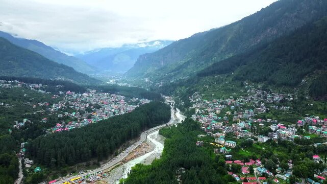 Aerial view of manali with the beas river in himachal pradesh India. Himalayan mountains and colourful local houses nestled in the hills of manali himachal pradesh India.