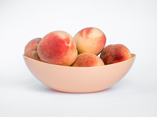 White Swan Peaches in a Plastic Vase Isolated on White Background