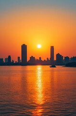 Fototapeta premium A city skyline is reflected in the water as the sun sets