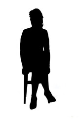 front view of the silhouette of a women sitting on a chair with his legs crossed