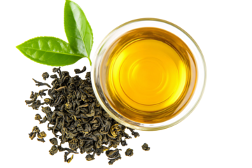 a bowl of tea with leaves and a green leaf