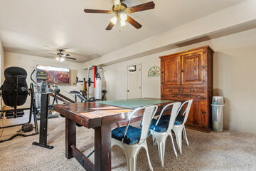 Home gym and dining area combined in cozy interior space with wooden furniture