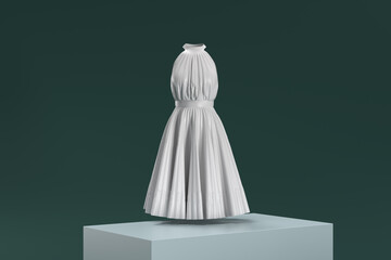 A white dress is displayed on a pedestal