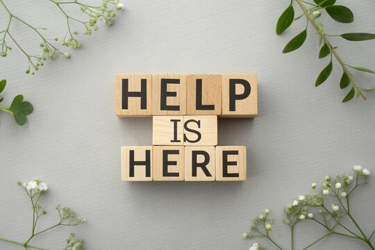 'Help is Here' with wooden blocks and floral decor