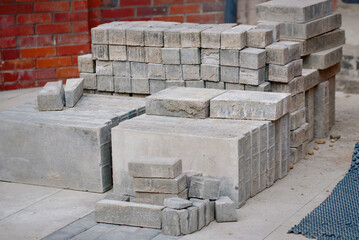 Pile of paving stones and bricks prepared for installation, process of laying bricks for durable...