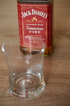 Vertical shot of Jack Daniels Tennessee Fire flavored whiskey in a glass bottle on a table