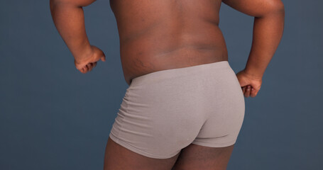 Back, buttocks and underwear in studio for body positivity, dance and self care. Man, topless and...