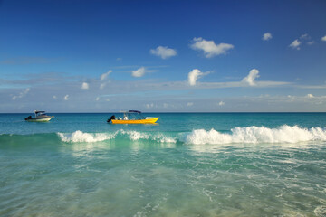 Boats anchored at Fayaoue beach on the coast of Ouvea lagoon, Mouli and Ouvea Islands, New Caledonia