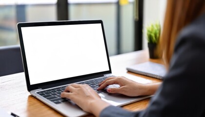 Woman working on laptop with white screen in office 