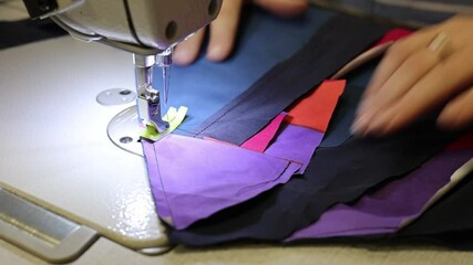 The process of sewing clothes from the remains of textiles and cut clothes. Upcycling, recycling, conscious consumption, zero waste. Youth clothing brand, sustainable fashion, reuse of materials.