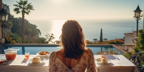 Young woman sitting at a table in a hotel restaurant back view, summer vacation in a luxury room by the sea. Generative AI.