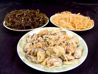 Seafood dishes on white plates