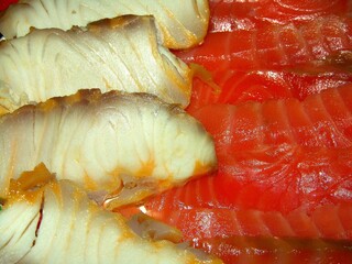 White and red fish slices over red background