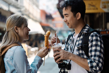 Travel adventure exploring local cuisine with friends street market food content urban setting close-up view culinary experience