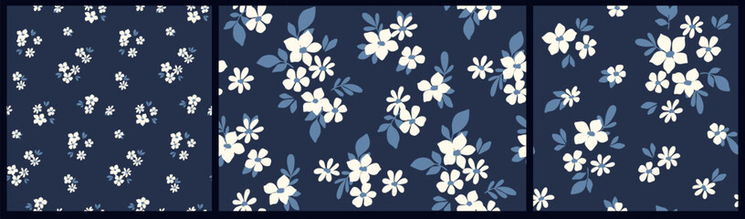 Seamless floral pattern, liberty ditsy print with small white flowers on a dark blue field. Cute botanical design: simple hand drawn plants, tiny flowers, leaves in mini bouquets. Vector illustration. © Yulya i Kot