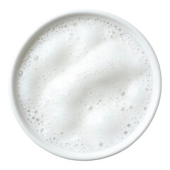 A close-up view of a frothy, creamy liquid in a round white bowl.