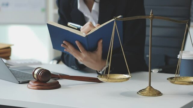 Judge gavel with Justice lawyers having team meeting at law firm background. Concepts of Law and Legal services.