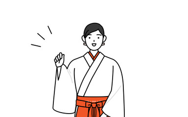 ガッツポーズをする神社の巫女、白衣と緋袴
