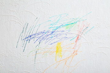 Drawn colorful scratches lines with markers on white wallpaper background. Closeup. Draw of naughty...