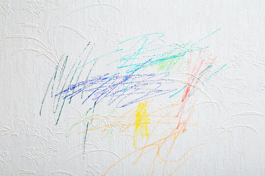 Fototapeta Drawn colorful scratches lines with markers on white wallpaper background. Closeup. Draw of naughty little kid. Front view.