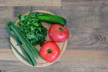 a wooden board with a bunch of vegetables on it top view cooking